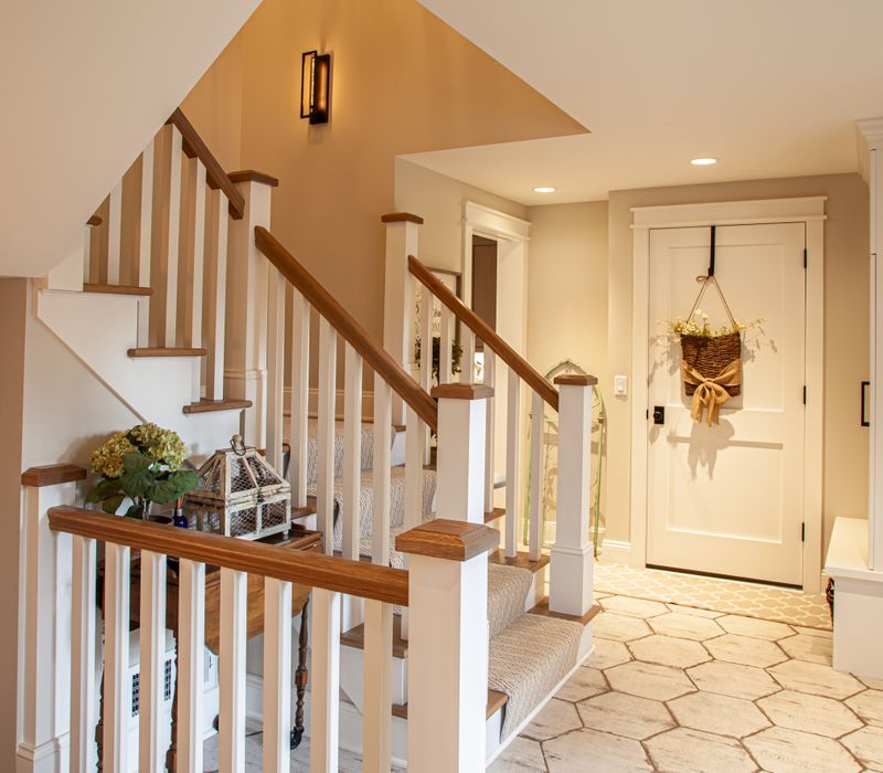 This country home has a rustic chic style with rough-hewn exposed wood beams, hand-painted terra cotta tiles, and a stone turret.