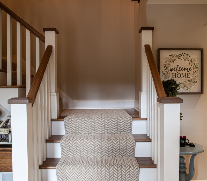 This country home has a rustic chic style with rough-hewn exposed wood beams, hand-painted terra cotta tiles, and a stone turret.