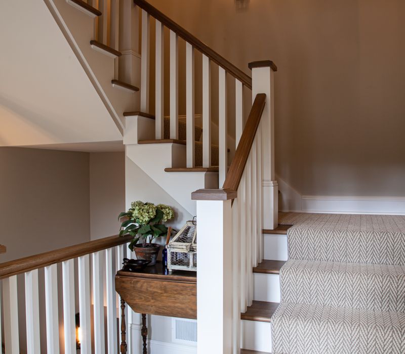This country home has a rustic chic style with rough-hewn exposed wood beams, hand-painted terra cotta tiles, and a stone turret.