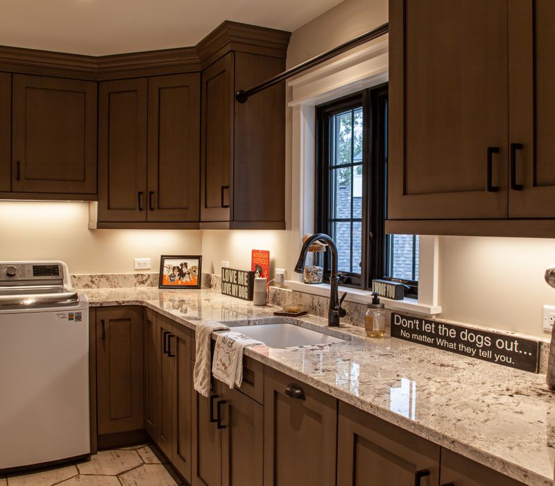 This country home has a rustic chic style with rough-hewn exposed wood beams, hand-painted terra cotta tiles, and a stone turret.