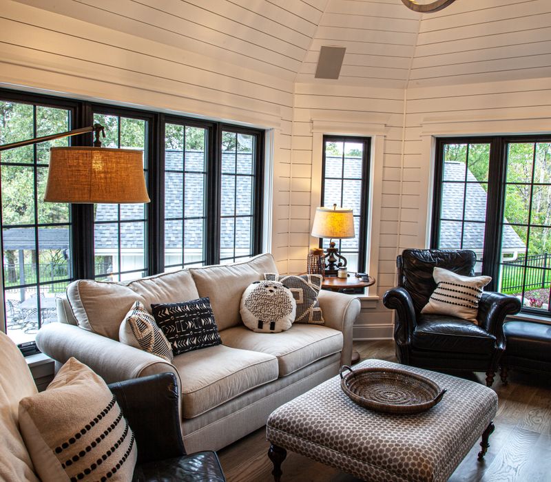 This country home has a rustic chic style with rough-hewn exposed wood beams, hand-painted terra cotta tiles, and a stone turret.