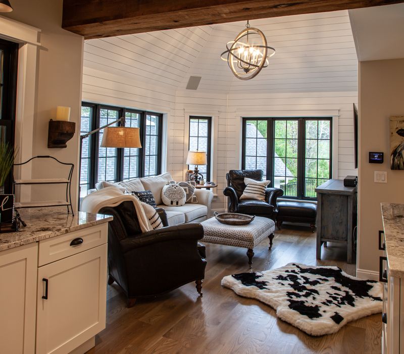 This country home has a rustic chic style with rough-hewn exposed wood beams, hand-painted terra cotta tiles, and a stone turret.