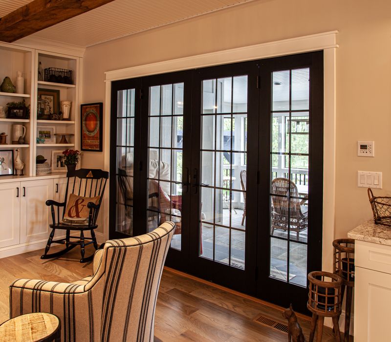 This country home has a rustic chic style with rough-hewn exposed wood beams, hand-painted terra cotta tiles, and a stone turret.