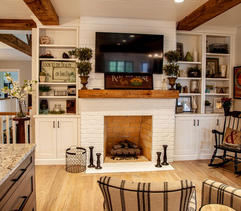 This country home has a rustic chic style with rough-hewn exposed wood beams, hand-painted terra cotta tiles, and a stone turret.