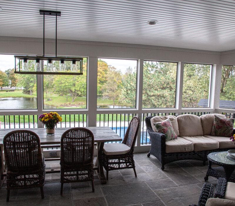 This country home has a rustic chic style with rough-hewn exposed wood beams, hand-painted terra cotta tiles, and a stone turret.
