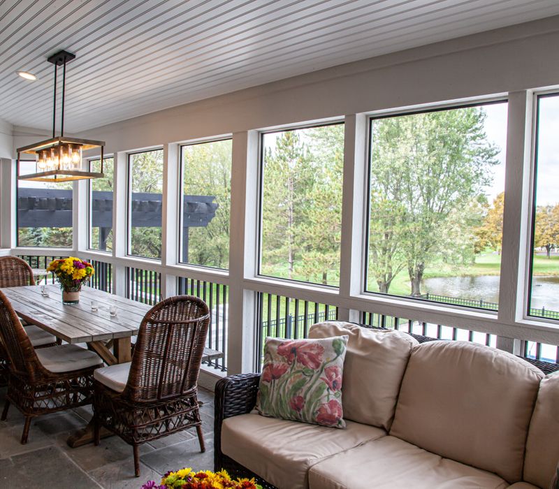This country home has a rustic chic style with rough-hewn exposed wood beams, hand-painted terra cotta tiles, and a stone turret.