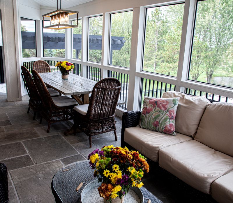 This country home has a rustic chic style with rough-hewn exposed wood beams, hand-painted terra cotta tiles, and a stone turret.