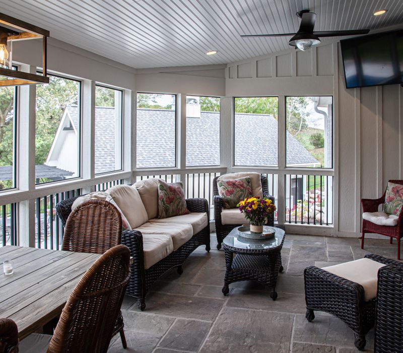 This country home has a rustic chic style with rough-hewn exposed wood beams, hand-painted terra cotta tiles, and a stone turret.