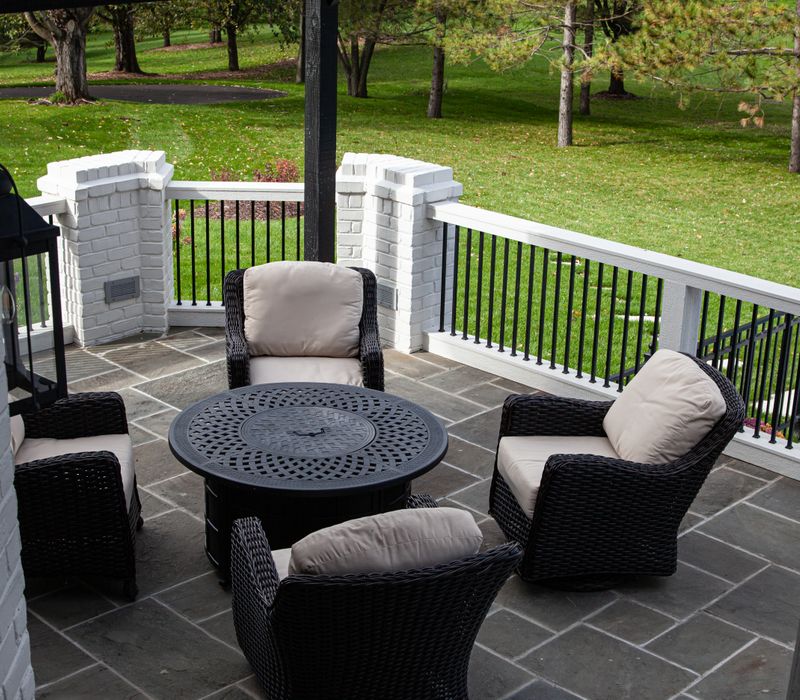 This country home has a rustic chic style with rough-hewn exposed wood beams, hand-painted terra cotta tiles, and a stone turret.