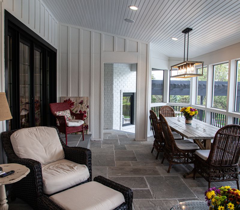 This country home has a rustic chic style with rough-hewn exposed wood beams, hand-painted terra cotta tiles, and a stone turret.