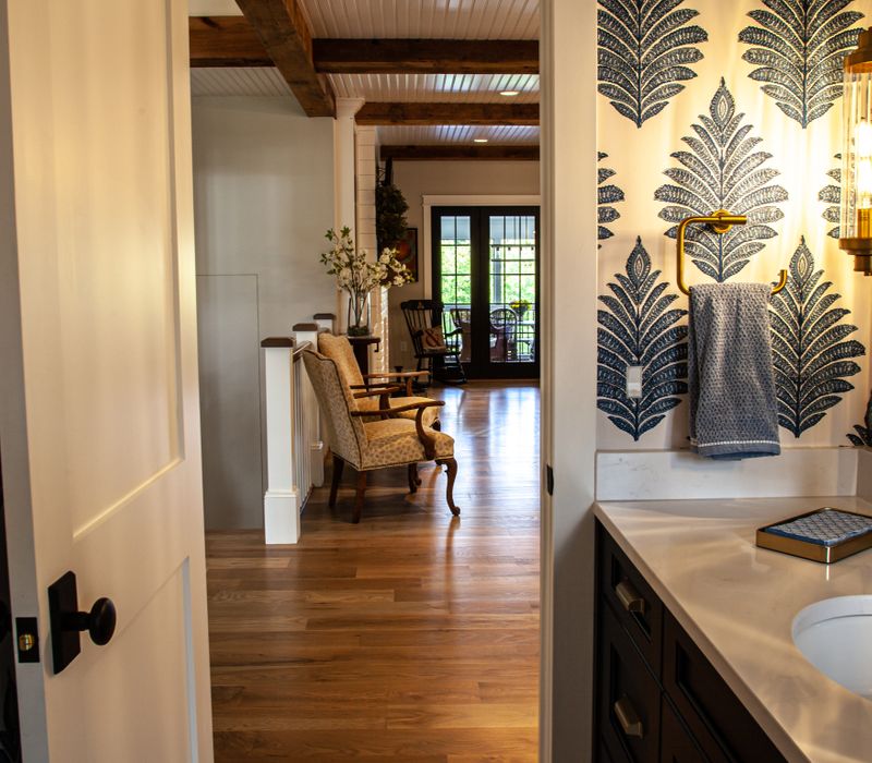 This country home has a rustic chic style with rough-hewn exposed wood beams, hand-painted terra cotta tiles, and a stone turret.