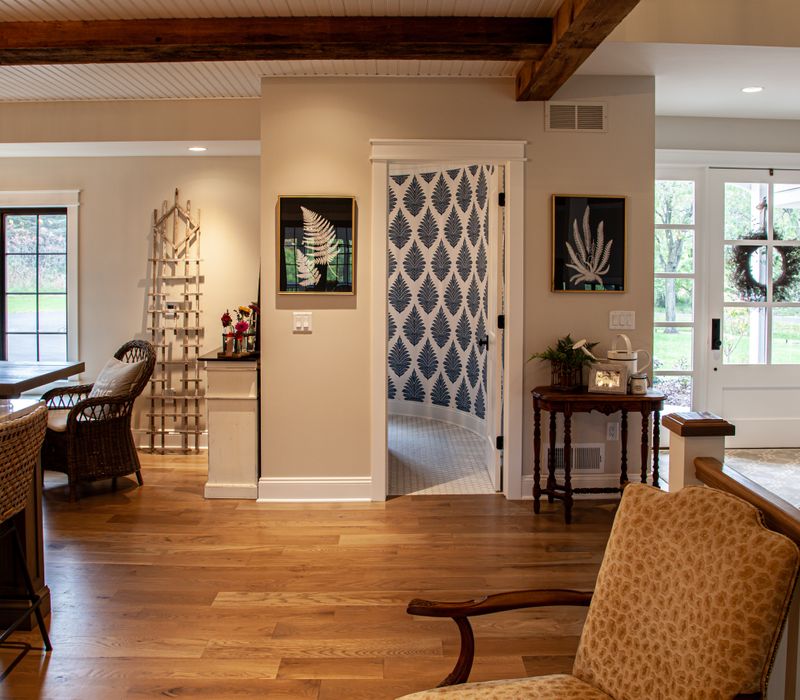 This country home has a rustic chic style with rough-hewn exposed wood beams, hand-painted terra cotta tiles, and a stone turret.