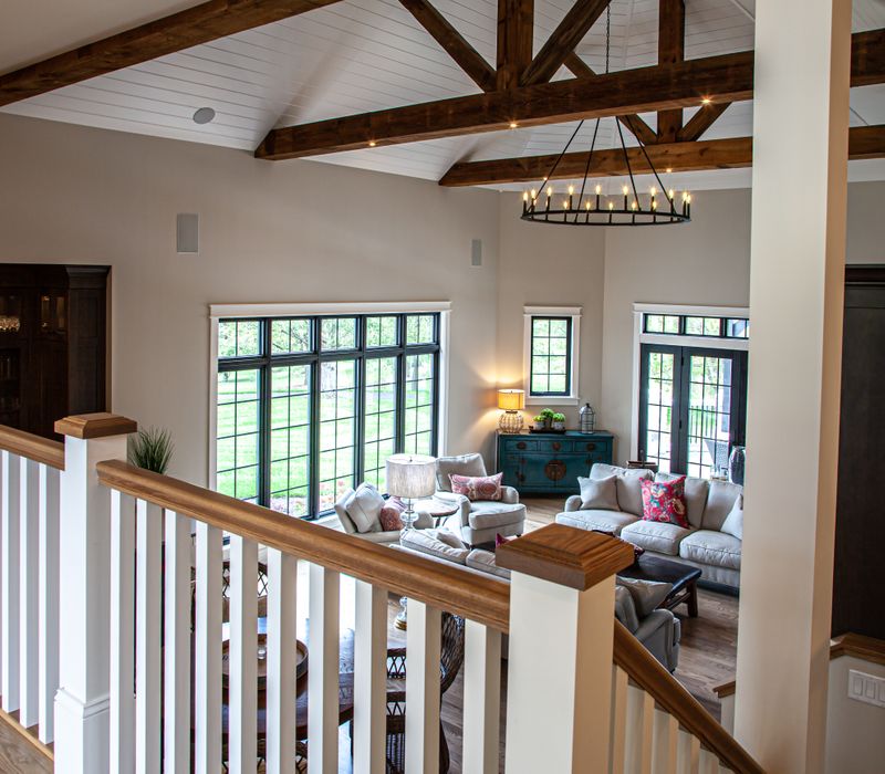 This country home has a rustic chic style with rough-hewn exposed wood beams, hand-painted terra cotta tiles, and a stone turret.