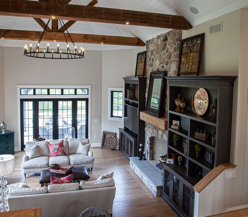 This country home has a rustic chic style with rough-hewn exposed wood beams, hand-painted terra cotta tiles, and a stone turret.