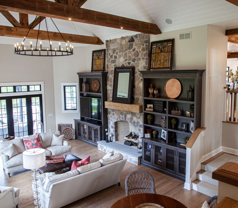 This country home has a rustic chic style with rough-hewn exposed wood beams, hand-painted terra cotta tiles, and a stone turret.