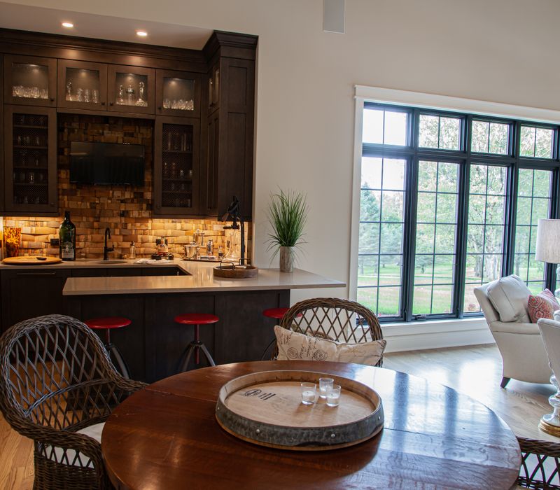 This country home has a rustic chic style with rough-hewn exposed wood beams, hand-painted terra cotta tiles, and a stone turret.