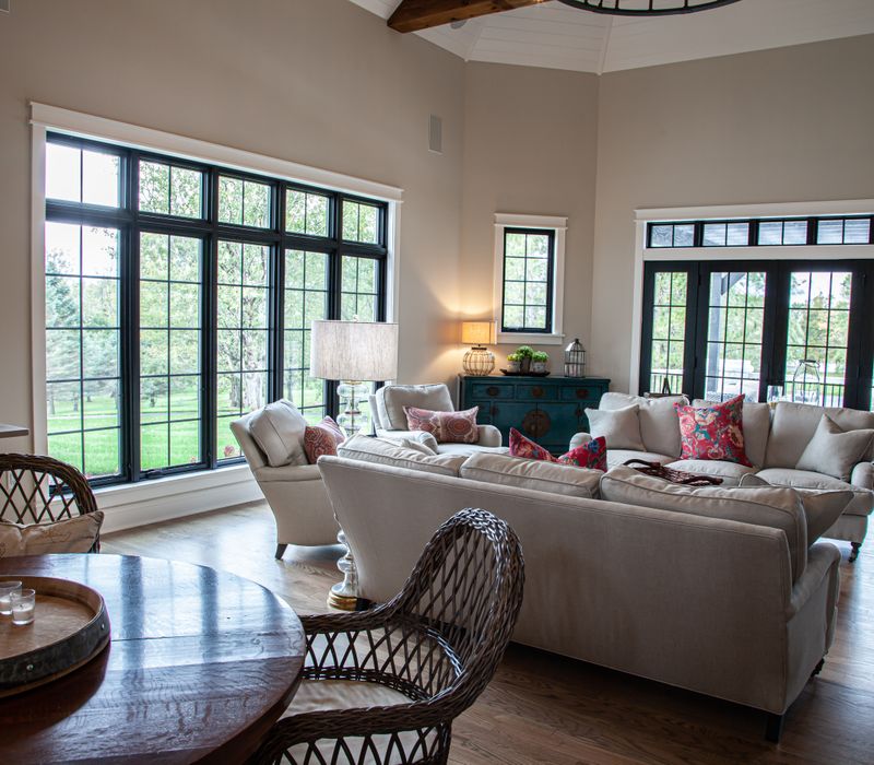This country home has a rustic chic style with rough-hewn exposed wood beams, hand-painted terra cotta tiles, and a stone turret.