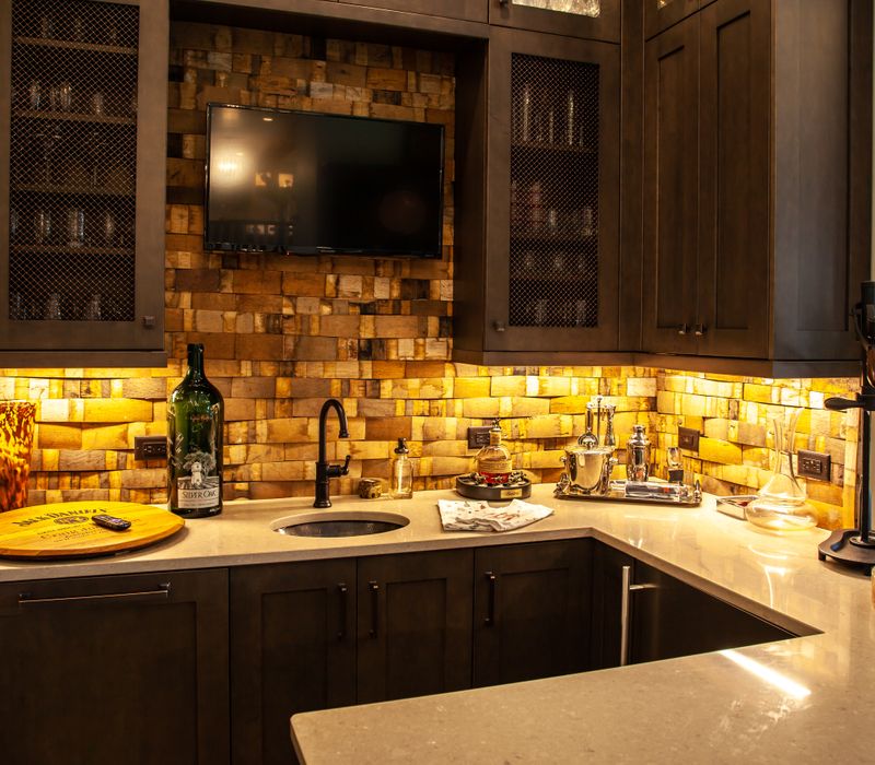 This country home has a rustic chic style with rough-hewn exposed wood beams, hand-painted terra cotta tiles, and a stone turret.