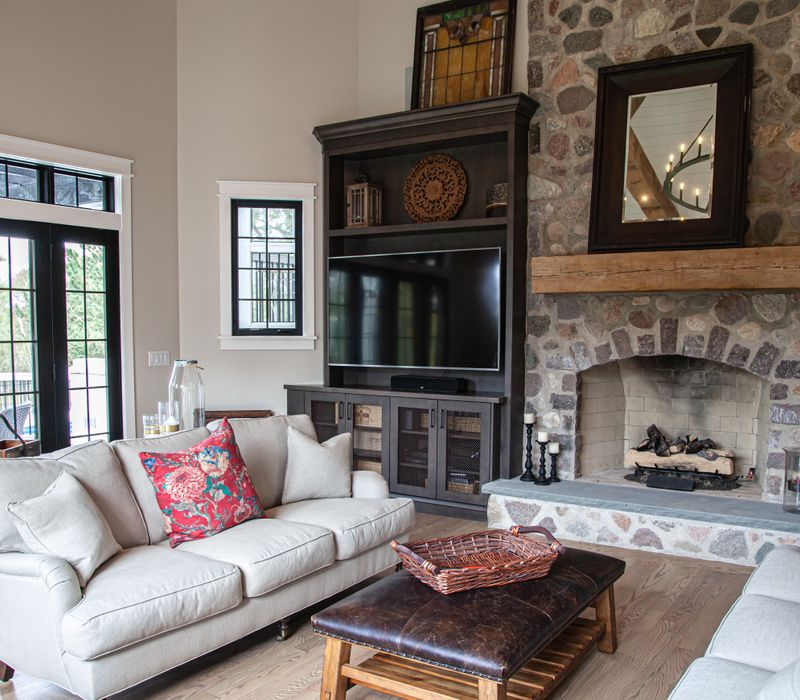 This country home has a rustic chic style with rough-hewn exposed wood beams, hand-painted terra cotta tiles, and a stone turret.