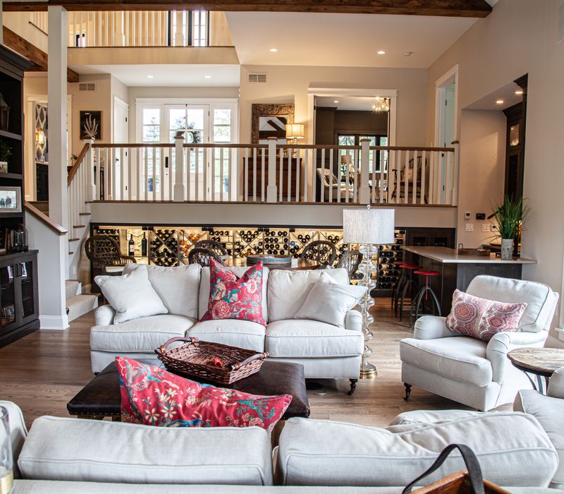 This country home has a rustic chic style with rough-hewn exposed wood beams, hand-painted terra cotta tiles, and a stone turret.