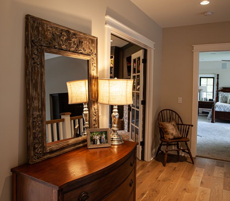 This country home has a rustic chic style with rough-hewn exposed wood beams, hand-painted terra cotta tiles, and a stone turret.