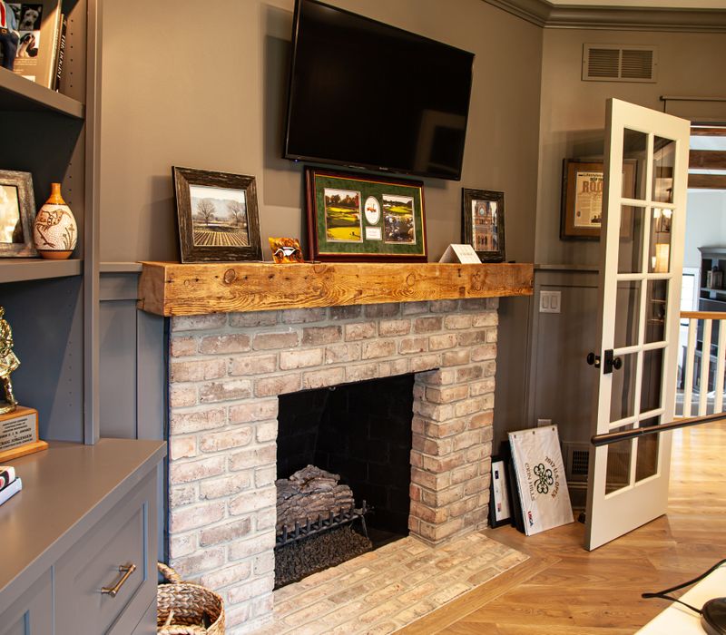 This country home has a rustic chic style with rough-hewn exposed wood beams, hand-painted terra cotta tiles, and a stone turret.