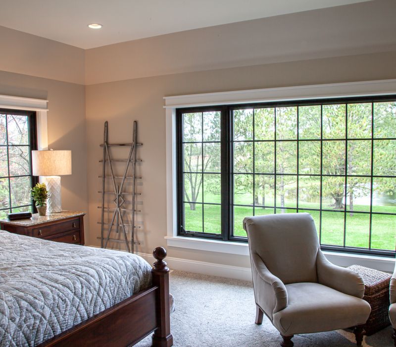 This country home has a rustic chic style with rough-hewn exposed wood beams, hand-painted terra cotta tiles, and a stone turret.