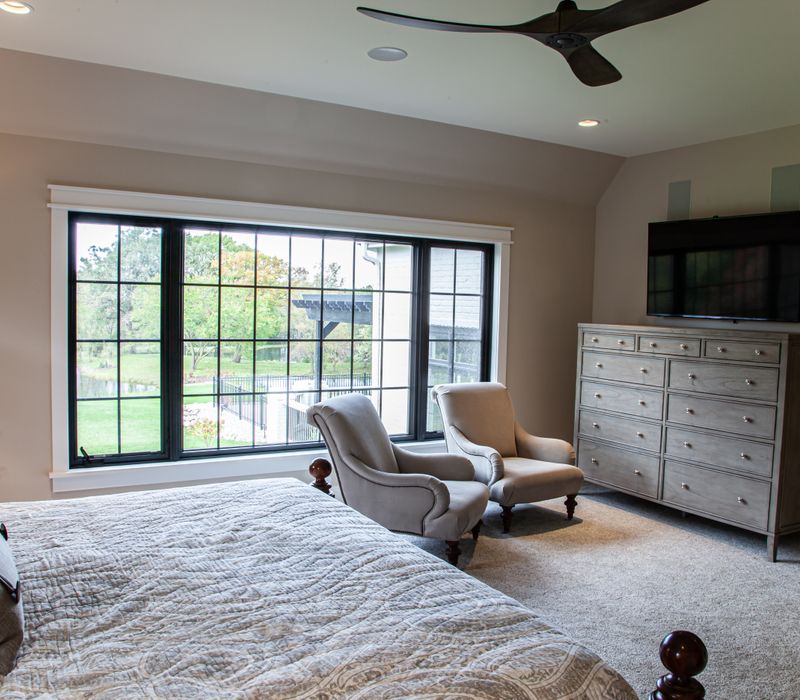 This country home has a rustic chic style with rough-hewn exposed wood beams, hand-painted terra cotta tiles, and a stone turret.