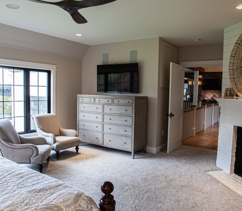 This country home has a rustic chic style with rough-hewn exposed wood beams, hand-painted terra cotta tiles, and a stone turret.