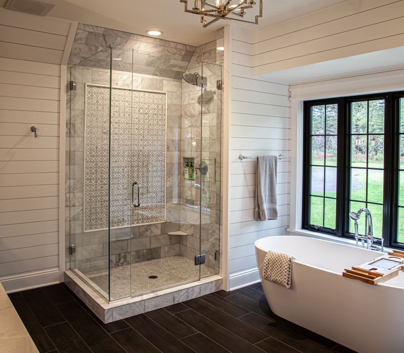 This country home has a rustic chic style with rough-hewn exposed wood beams, hand-painted terra cotta tiles, and a stone turret.