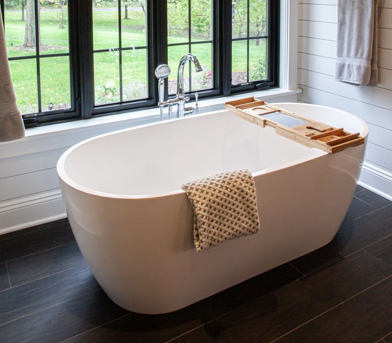 This country home has a rustic chic style with rough-hewn exposed wood beams, hand-painted terra cotta tiles, and a stone turret.