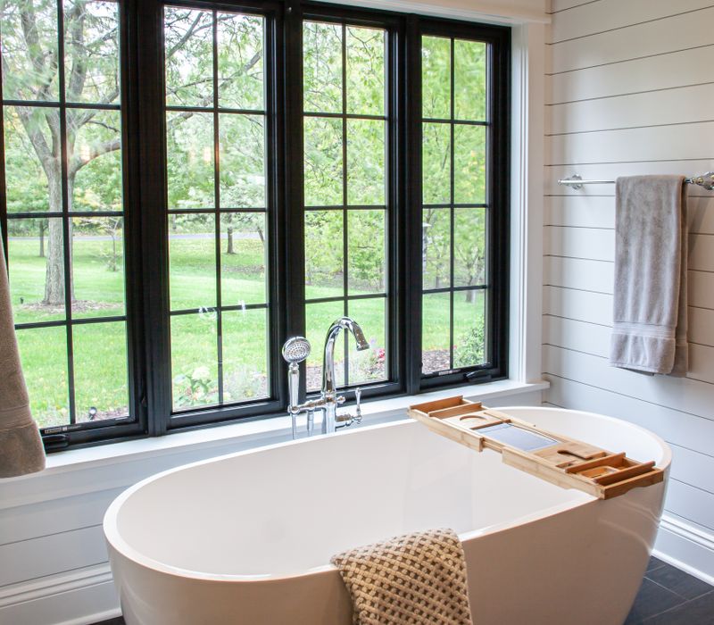 This country home has a rustic chic style with rough-hewn exposed wood beams, hand-painted terra cotta tiles, and a stone turret.