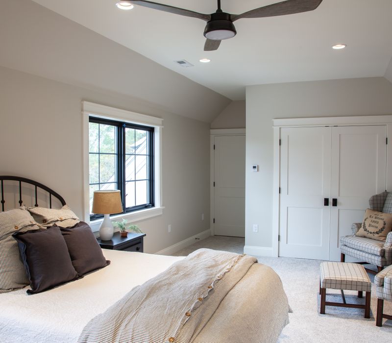 This country home has a rustic chic style with rough-hewn exposed wood beams, hand-painted terra cotta tiles, and a stone turret.