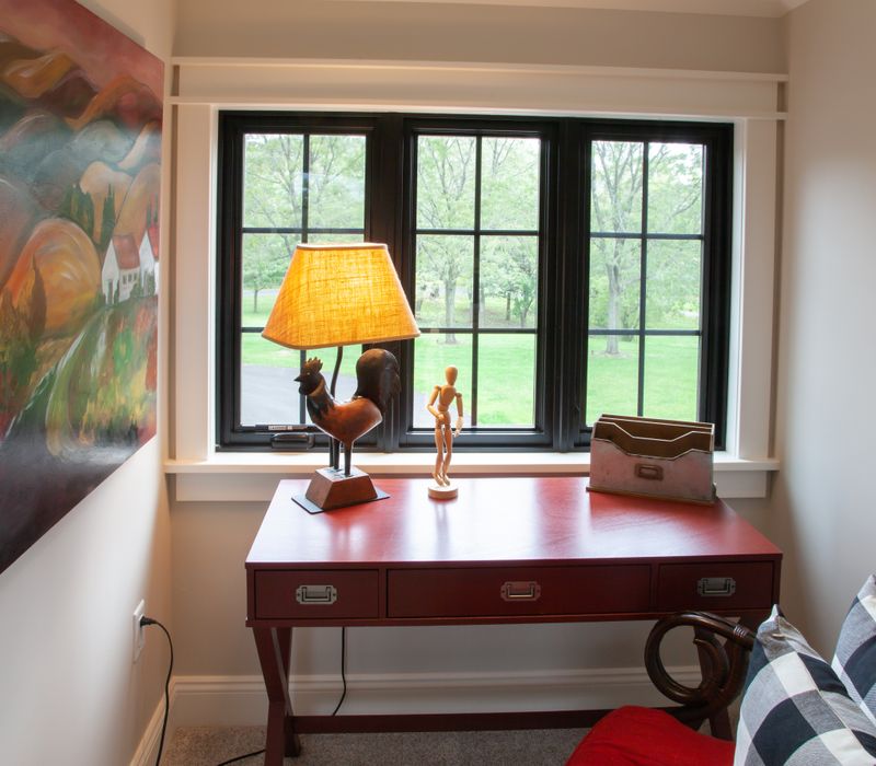 This country home has a rustic chic style with rough-hewn exposed wood beams, hand-painted terra cotta tiles, and a stone turret.