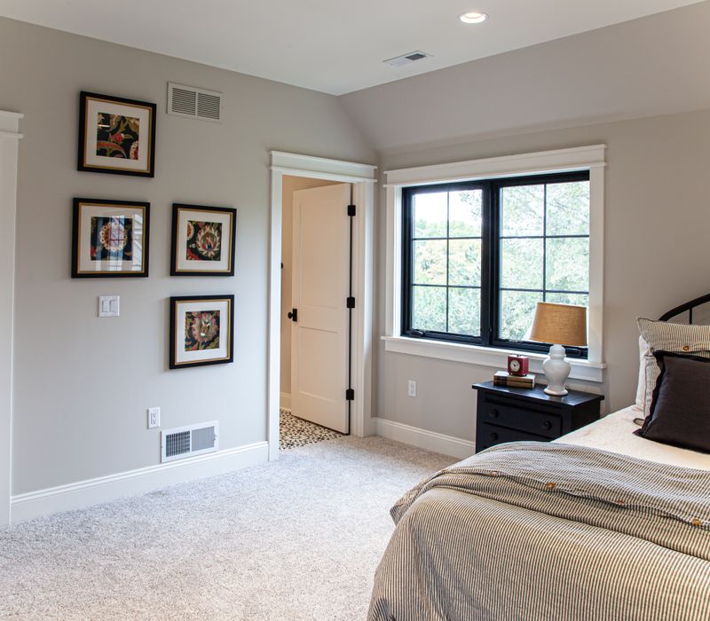This country home has a rustic chic style with rough-hewn exposed wood beams, hand-painted terra cotta tiles, and a stone turret.
