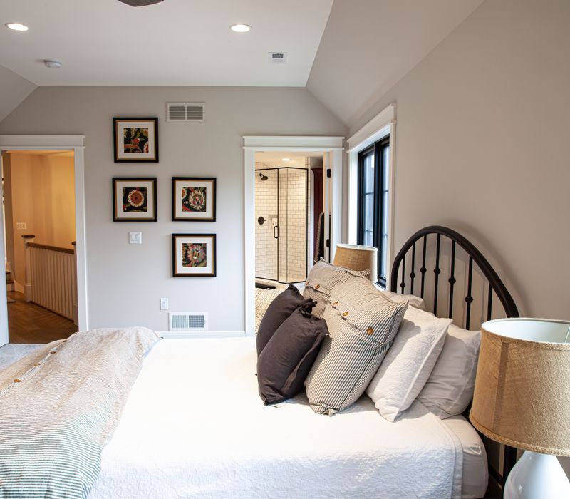 This country home has a rustic chic style with rough-hewn exposed wood beams, hand-painted terra cotta tiles, and a stone turret.