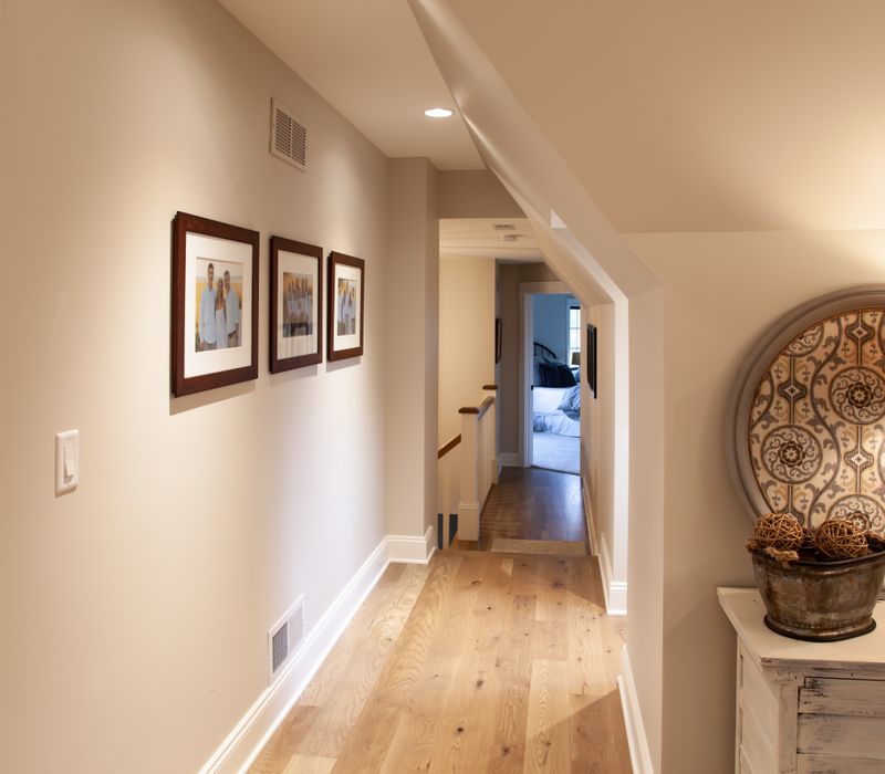 This country home has a rustic chic style with rough-hewn exposed wood beams, hand-painted terra cotta tiles, and a stone turret.