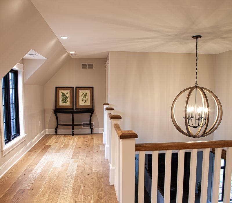 This country home has a rustic chic style with rough-hewn exposed wood beams, hand-painted terra cotta tiles, and a stone turret.