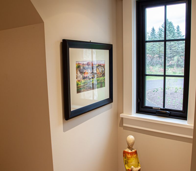 This country home has a rustic chic style with rough-hewn exposed wood beams, hand-painted terra cotta tiles, and a stone turret.