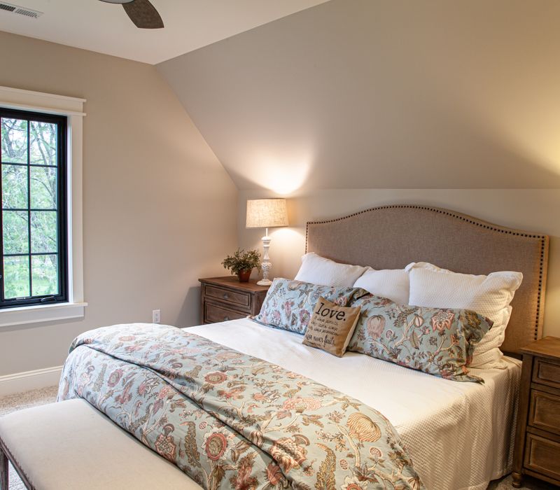 This country home has a rustic chic style with rough-hewn exposed wood beams, hand-painted terra cotta tiles, and a stone turret.