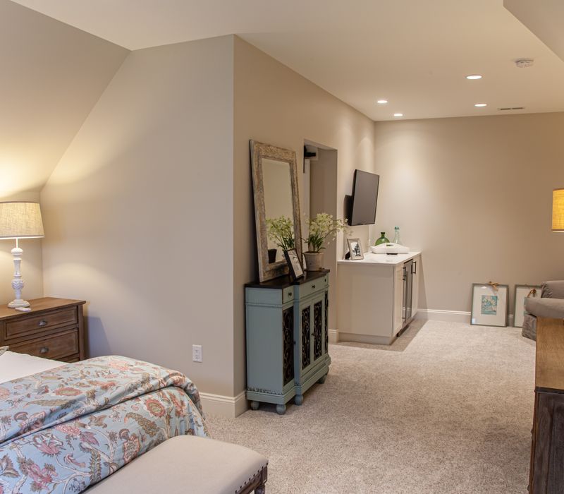 This country home has a rustic chic style with rough-hewn exposed wood beams, hand-painted terra cotta tiles, and a stone turret.