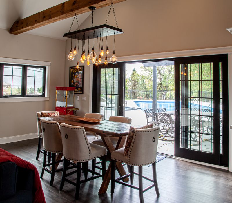 This country home has a rustic chic style with rough-hewn exposed wood beams, hand-painted terra cotta tiles, and a stone turret.