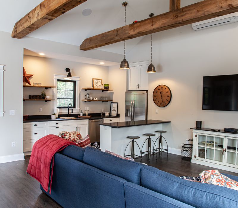 This country home has a rustic chic style with rough-hewn exposed wood beams, hand-painted terra cotta tiles, and a stone turret.