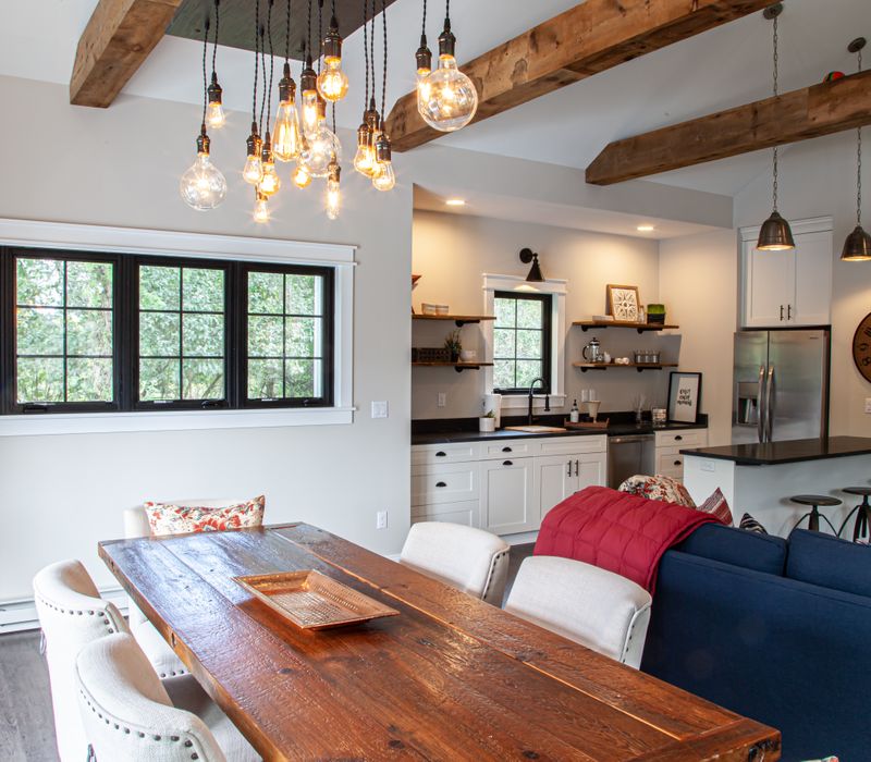 This country home has a rustic chic style with rough-hewn exposed wood beams, hand-painted terra cotta tiles, and a stone turret.