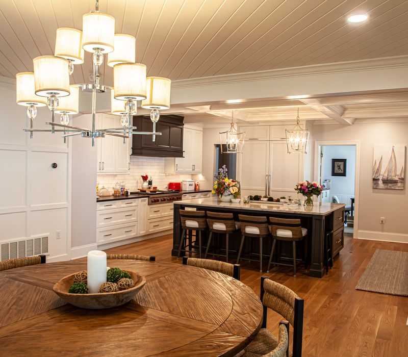 Subway tiles, white cabinetry, and coffered and beadboard ceilings add a sophisticated touch to this comfortable classic home. 