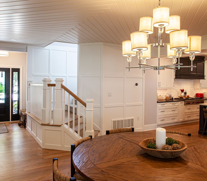 Subway tiles, white cabinetry, and coffered and beadboard ceilings add a sophisticated touch to this comfortable classic home. 