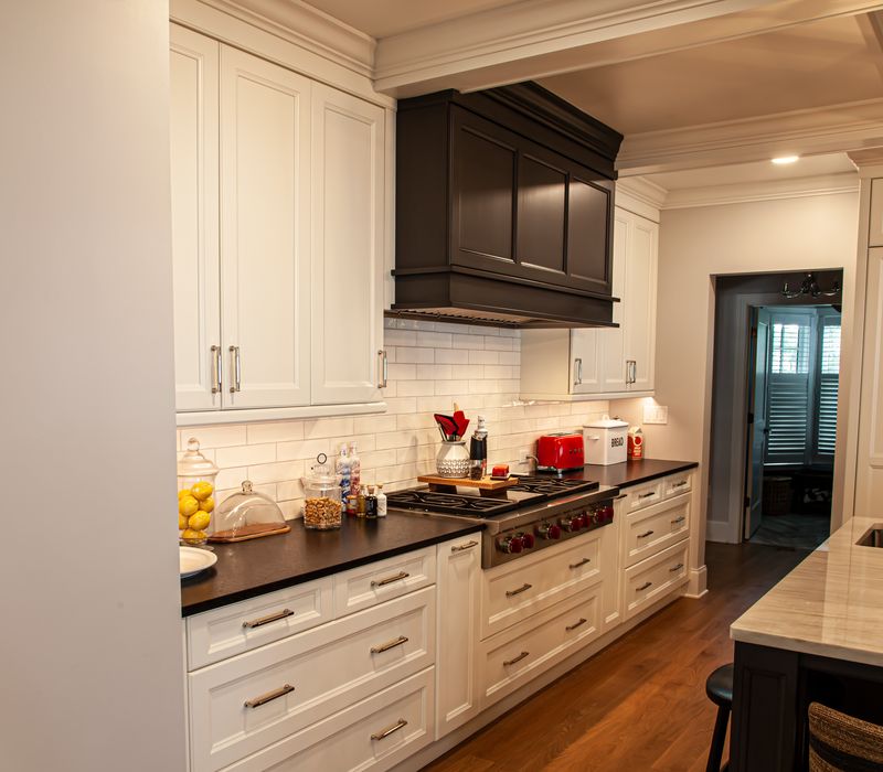 Subway tiles, white cabinetry, and coffered and beadboard ceilings add a sophisticated touch to this comfortable classic home. 