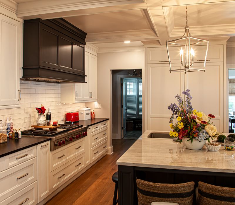 Subway tiles, white cabinetry, and coffered and beadboard ceilings add a sophisticated touch to this comfortable classic home. 