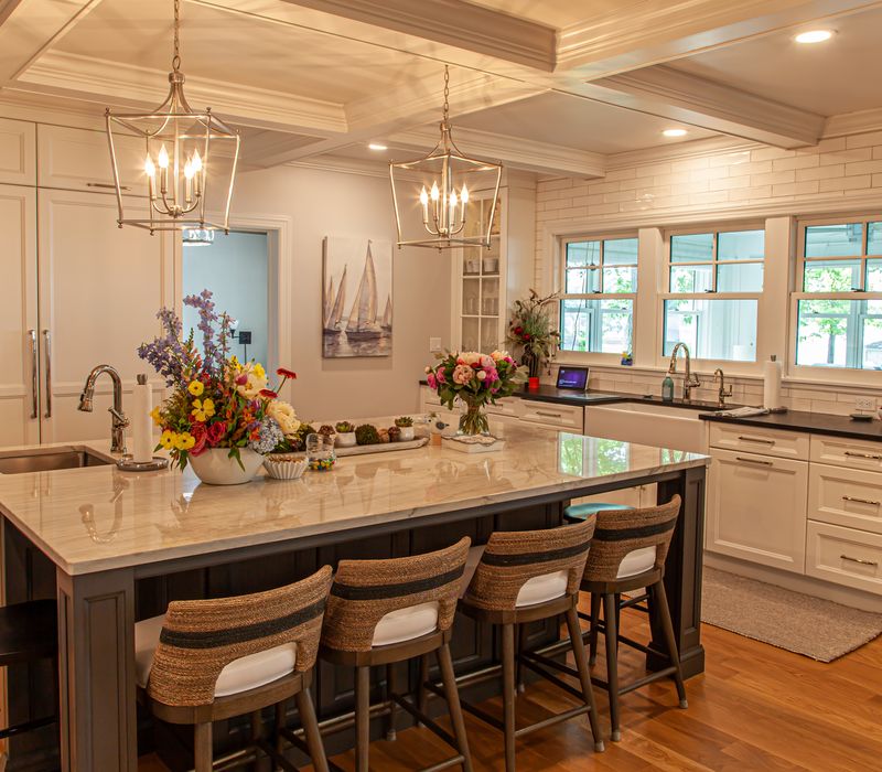 Subway tiles, white cabinetry, and coffered and beadboard ceilings add a sophisticated touch to this comfortable classic home. 