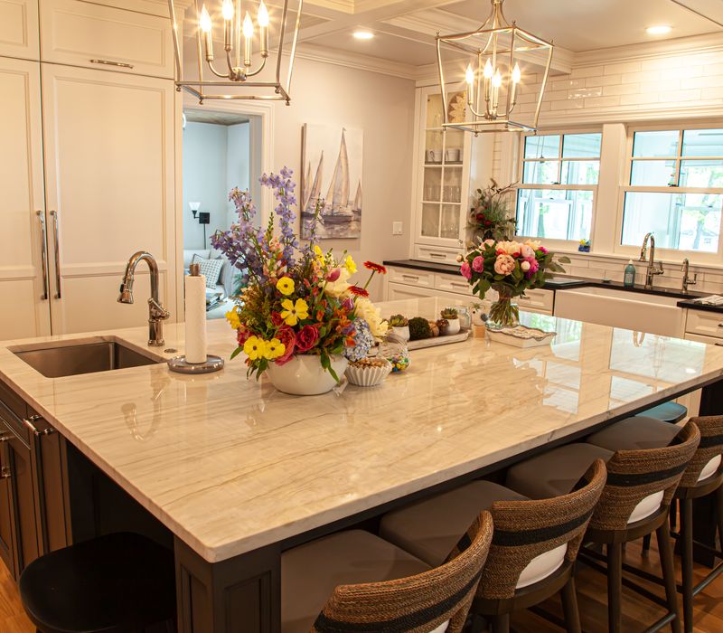 Subway tiles, white cabinetry, and coffered and beadboard ceilings add a sophisticated touch to this comfortable classic home. 